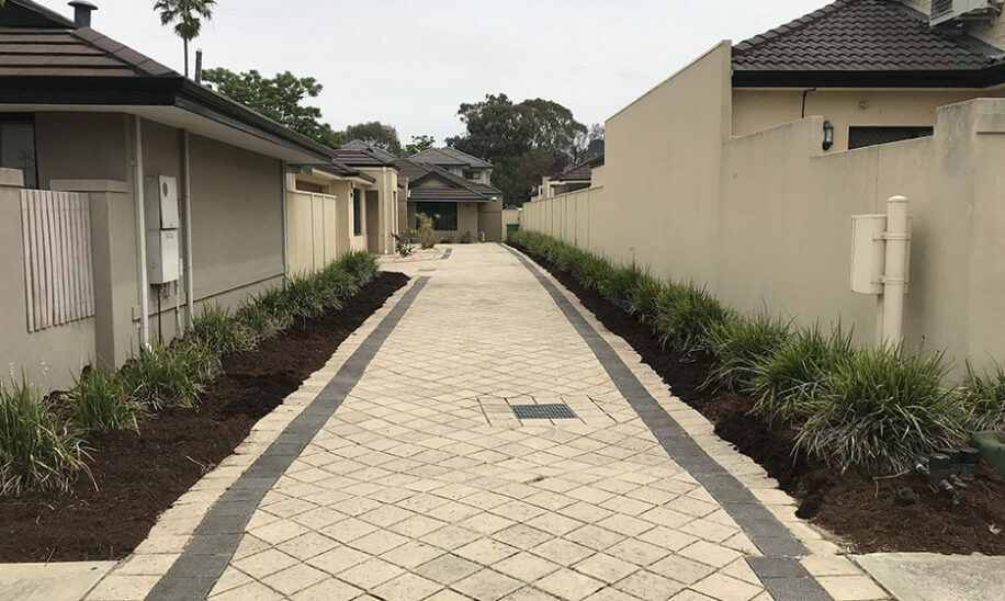Block paved strata driveway after weed removal and shrub planting